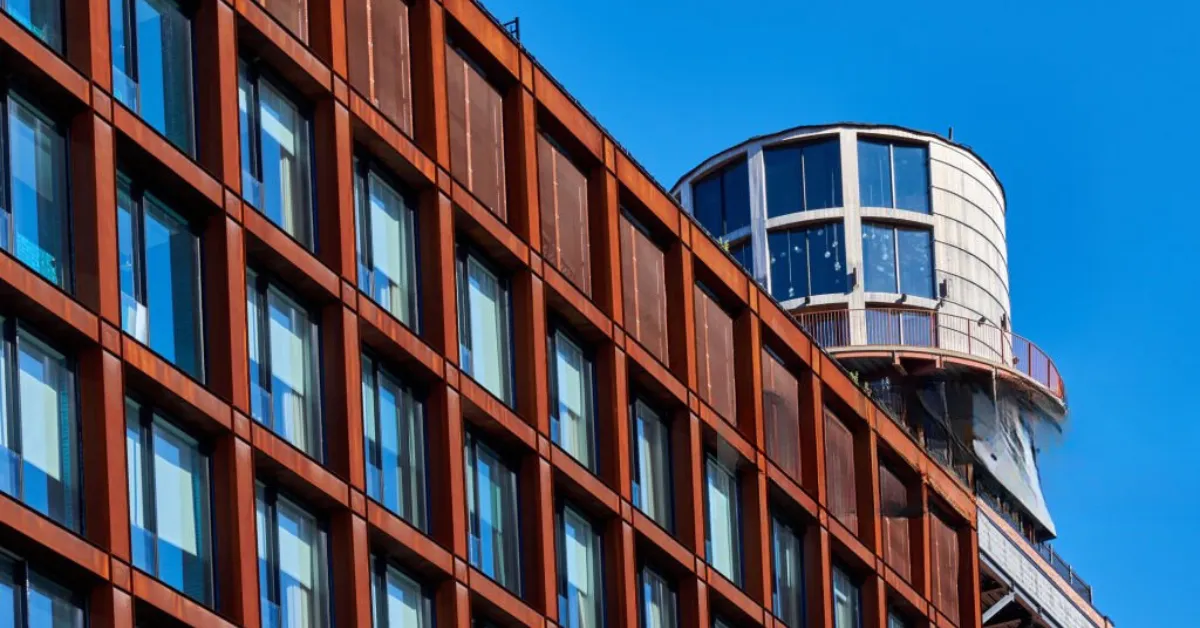 A close-up of the rust-coloured corten steel facade of the Arlo Williamsburg Hotel in Brooklyn, USA.